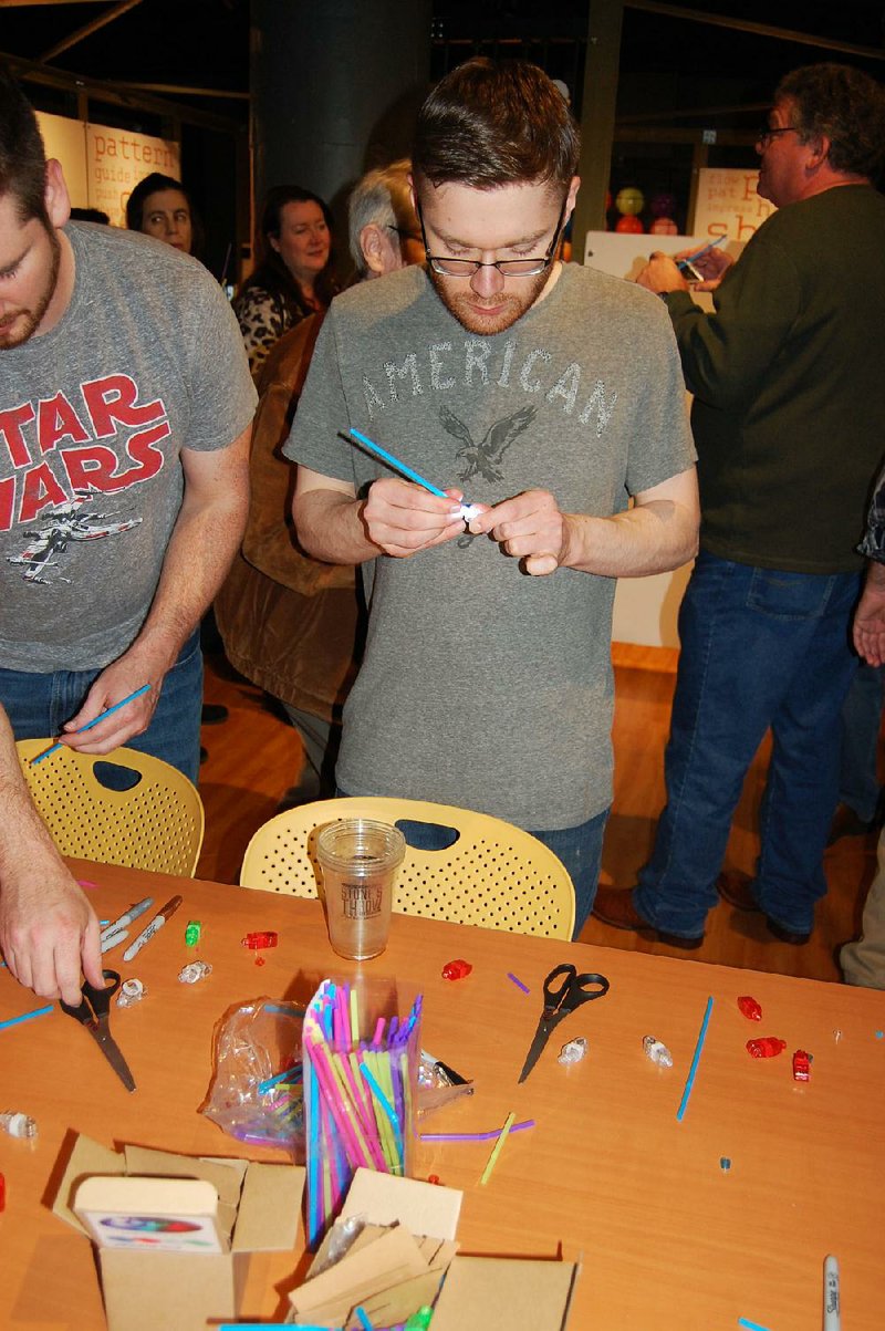 Visitors make LED light sabers at the Museum of Discovery’s Science After Dark Star Wars night. The museum will offer more hands-on activities at its family friendly Star Wars Science event Saturday.
