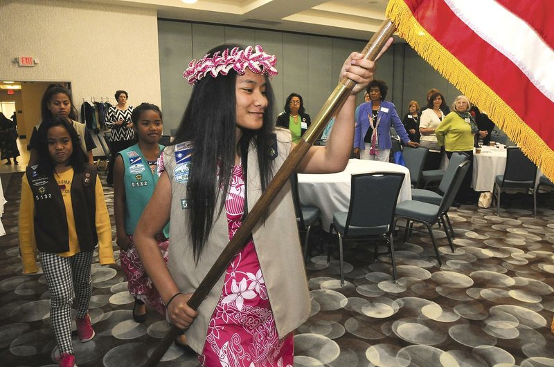 Henity Harry carries the American flag April 30 into the convention of the American Association of University Women in Fayetteville. Girl Scouts from Troop 5132 in Springdale — made up entirely of girls from the Marshall Islands — posted the colors at the gathering.