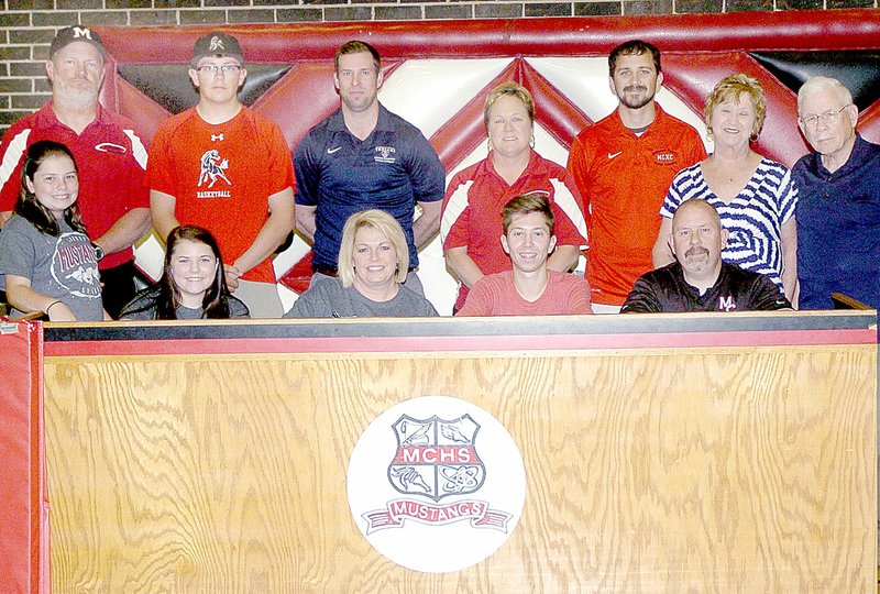 Photo by Rick Peck McDonald County&#8217;s Cole Cooper signed a letter of intent on May 5 to run cross country and track at Hannibal-LaGrange University in Hannibal, Mo. Shown are: front row from left, Peyton Cooper, Erin Cooper, Diane Cooper, Cole Cooper and Ben Cooper; and, back row from left, Bruce Stancell, Grant Cooper, Andy Lemons, Darbi Stancell, Henri Whitehead, Marilyn Cooper and Freddie Cooper. ^