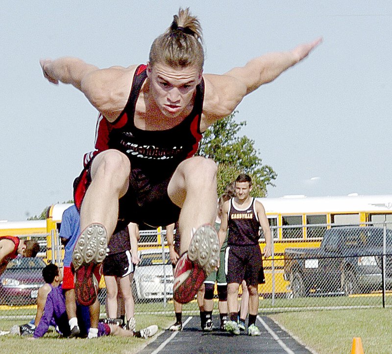 Photo by Rick Peck McDonald County&#8217;s Shane Russo stretches for the pit on his way to finishing fourth in the long jump at the Big 8 Conference Track and Field Championships held May 5 at East Newton High School.