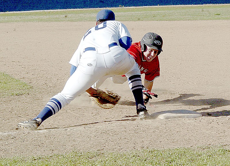 Photo by Rick Peck McDonald County&#8217;s Seth Shockley dives back to first base during the Mustangs&#8217; 8-3 win on May 4 at Carthage High School.