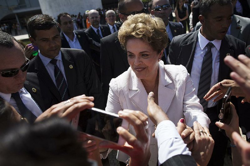 Brazilian President Dilma Rousseff greets supporters Thursday as she leaves the presidential palace in Brasilia shortly after the Senate voted to impeach her. “I am the victim of a great injustice,” she said, calling the day’s events a “coup” orchestrated by her political enemies. 