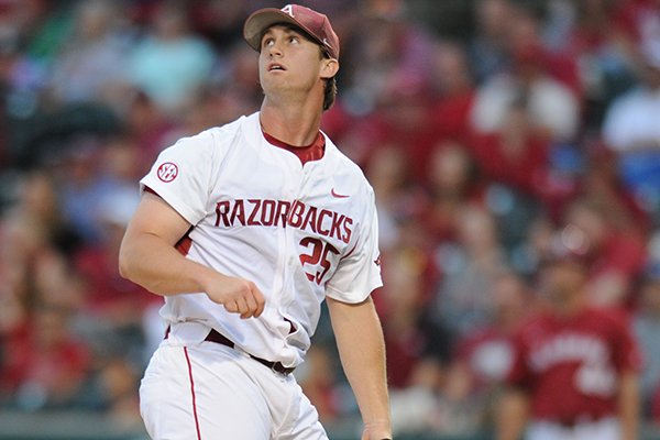 Arkansas starter Dominic Taccolini watches as a ball hit by Alabama right fielder Chandler Taylor Friday, May 13, 2016, during the Crimson Tide's four-run fourth inning at Baum Stadium in Fayetteville. 