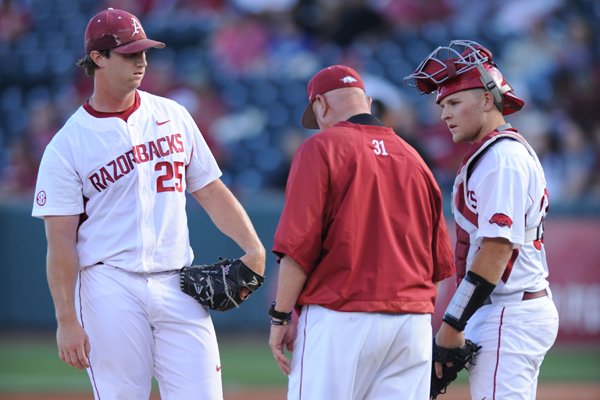 Arkansas starter Dominic Taccolini (left) listens as pitching coach Dave Jorn speaks alongside catcher Grant Koch against Alabama Friday, May 13, 2016, during the first inning at Baum Stadium in Fayetteville.