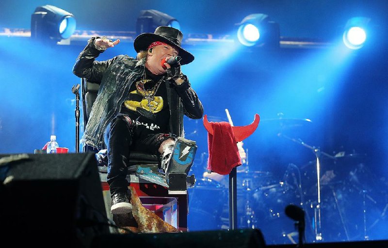 Axl Rose, recuperating from a broken foot, performs at a 2016 concert by AC/DC.
