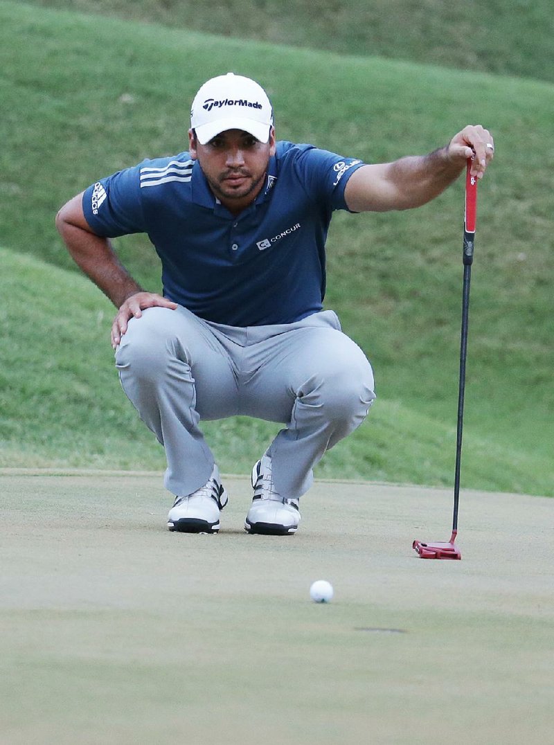 Jason Day eyes his birdie putt on the 14th green Friday during the second round of The Players Championship. Day made the putt just before play was called for darkness and he holds a three-shot lead.