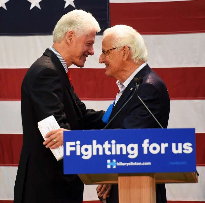 Former President Bill Clinton embraces Rep. Bill Pascrell, D-N.J., after Pascrell introduced him Friday at a rally for Hillary Clinton at Passaic County Community College in Paterson, N.J.