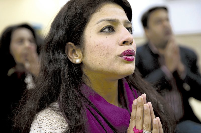 Namrta Bangia chants Buddhist prayers in New Delhi, India. Chanting Buddhist mantras is catching on among some Hindus in India as a way to relieve stress.