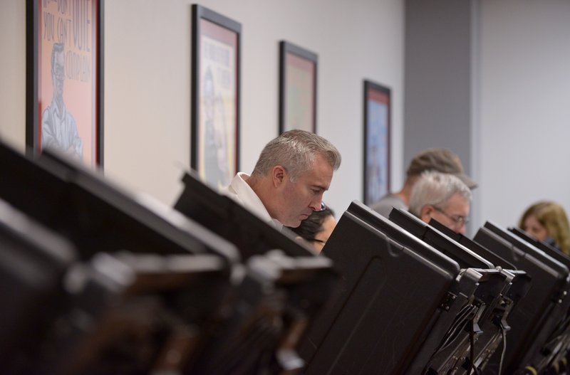 Michael Cochran of Bella Vista casts his ballot on Monday Feb. 29, 2016 during the last day of early voting at the Benton County Administration Building in downtown Bentonville. 