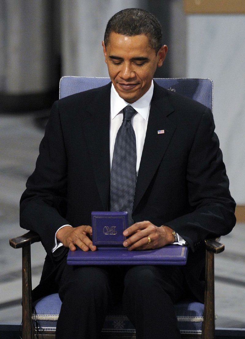 President Barack Obama holds his Nobel Peace Prize during a ceremony in Oslo, Norway, in December 2009. 