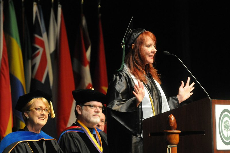 Amy Lyn Saferite speaks to graduates Saturday during the Northwest Arkansas Community College 26th annual Commencement held at Arend Arts Center at Bentonville High School. Saferite is one of three NWACC Distinguished Graduates who spoke during the college’s three commencement ceremonies held at 9 a.m., noon and 3 p.m. Graduates received diplomas and attended receptions hosted by the NWACC Alumni Association.