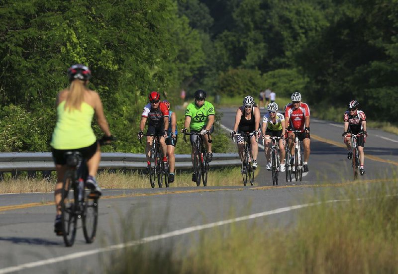 Cyclists ride Wednesday along the River Trail in Little Rock. The city will be recognized by the League of American Bicyclists as a Bicycle Friendly Community.
