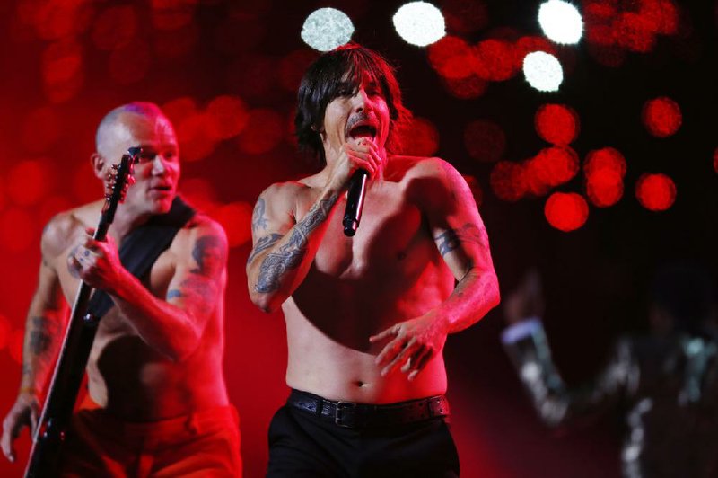 The Red Hot Chili Peppers band members Flea, left, and Anthony Kiedis perform during the halftime show of the NFL Super Bowl XLVIII football game Sunday, Feb. 2, 2014, in East Rutherford, N.J. 
