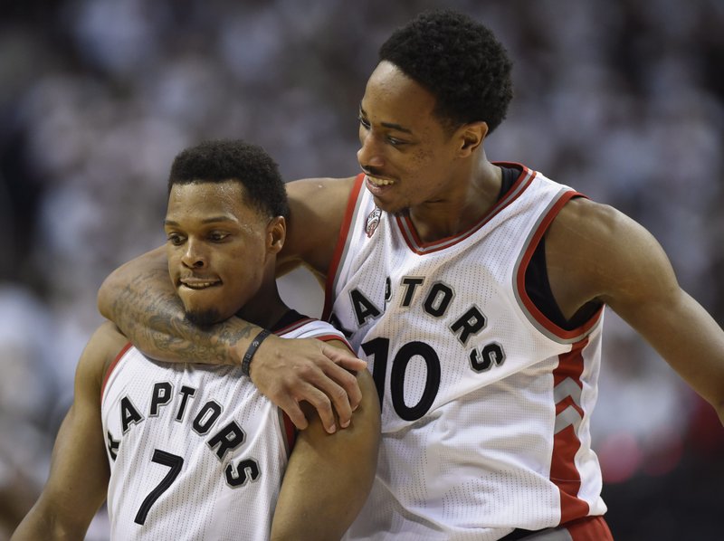 Toronto Raptors' DeMar DeRozan, right, and Kyle Lowry celebrate during the second half of Game 7 of the NBA basketball Eastern Conference semifinals against the Miami Heat in Toronto, Sunday, May 15, 2016. 