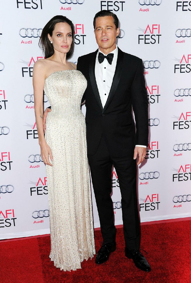 Angelina Jolie, left, and Brad Pitt arrive at the 2015 AFI Fest opening night premiere of "By The Sea" on Thursday, Nov. 5, 2015, in Los Angeles. 