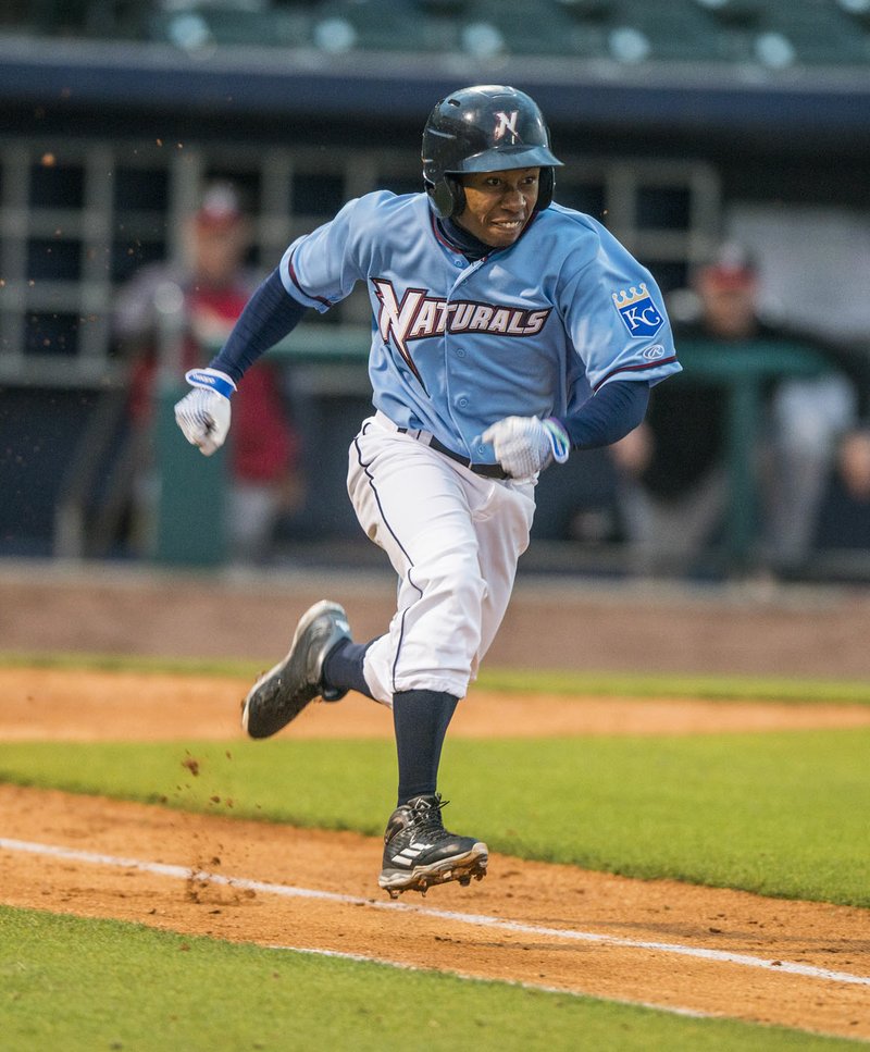Terrance Gore (0) of the Northwest Arkansas Naturals runs to first safely after a bunt against the Arkansas Travelers on Monday at Arvest Ballpark in Springdale.