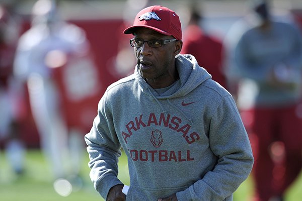 Arkansas assistant coach Reggie Mitchell speaks to his players Tuesday, March 29, 2016, during practice at the university's practice field on campus in Fayetteville.