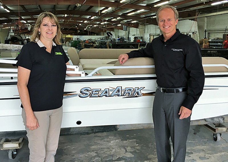 Robin McClendon, prior owner of SeaArk Boats (left), stands with Bill Yeargin, president and CEO of Correct Craft