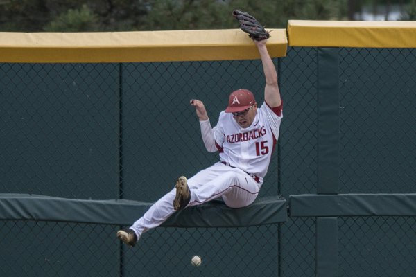 Jake Arledge (15) of Arkansas leaps for a ball as it leaves the ballpark against Missouri State on Tuesday, May 17, 2016, at Baum Stadium in Fayetteville.