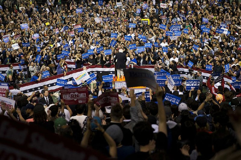 Bernie Sanders greets throngs of cheering supporters Tuesday evening at a campaign rally in Carson, Calif.