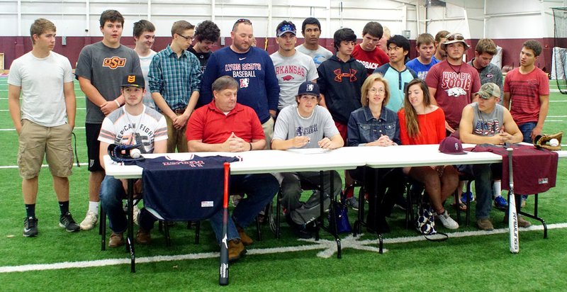 Photo by Randy Moll Zac Adkins (center) - accompanied by his parents, George and Kim, his sister, Jessica, his brother, Mac, his coach, Justin Ledbetter, and his Gentry teammates - signed a letter of intent on May 3 to play baseball for Lyon College in Batesville next year.