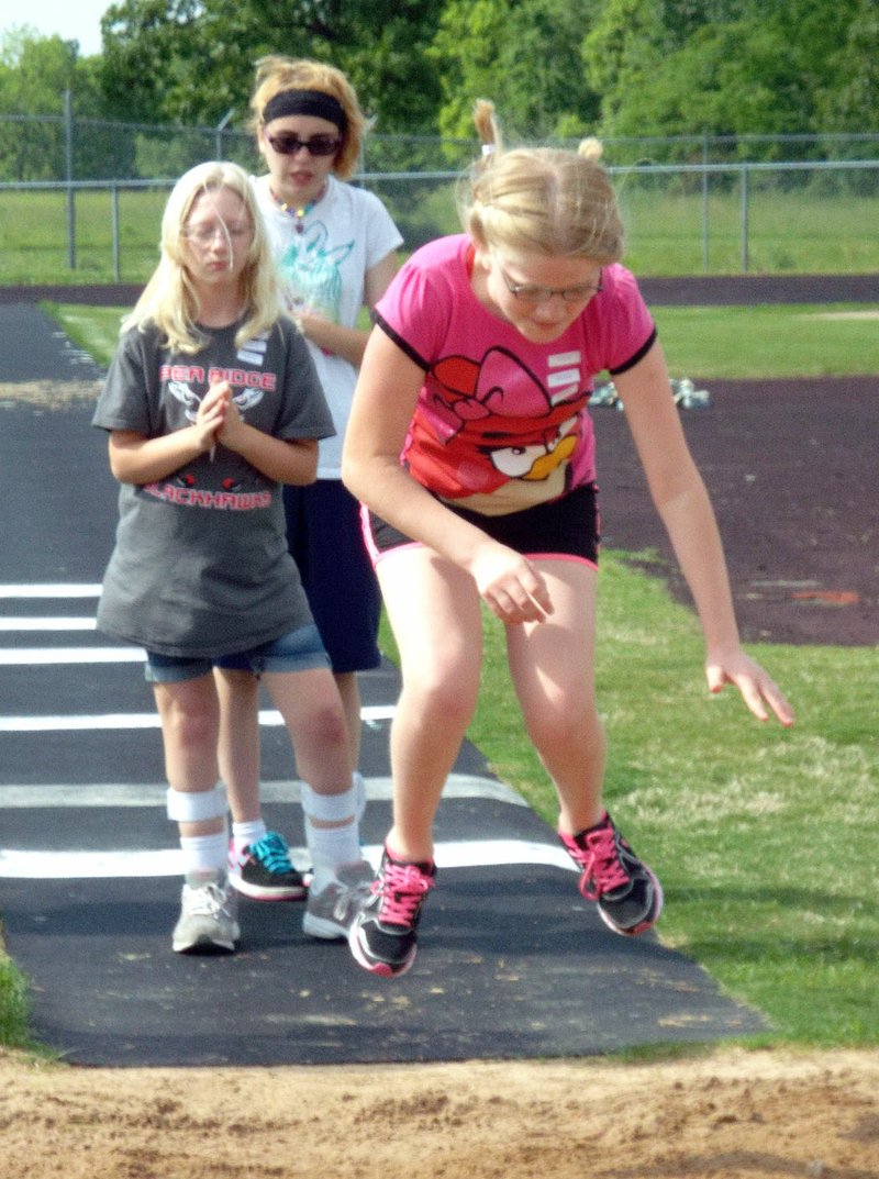 Photo by Randy Moll Mekalah Ramsey, a Gentry senior, proudly wears her gold medal won in the special education track meet held at Gentry High School on May 11.