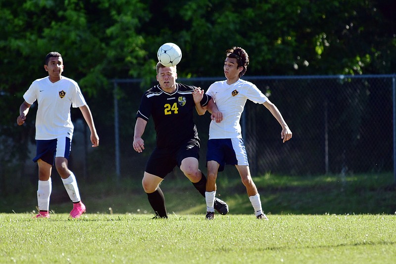 COURTESY PHOTO BY SHELLEY WILLIAMS Prairie Grove senior Cole Walker fights for positioning against a Jacksonville Lighthouse player during the Tigers 1-0 victory at the Class 5A State Tournament in Harrison on May 12.