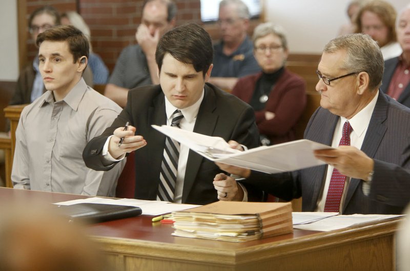 Samuel Robert Hill (left), 27, sits Monday in Judge Mark Lindsay’s courtroom with his defense attorneys John Bailey and John Barry Baker at the Washington County Courthouse in Fayetteville.