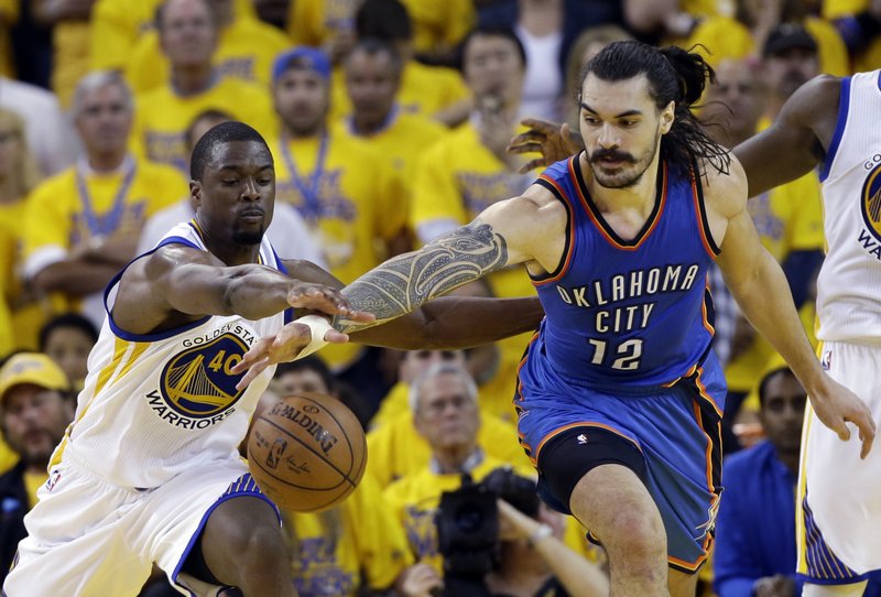 Oklahoma City Thunder's Steven Adams (12) fights for a loose ball against Golden State Warriors' Harrison Barnes (40) during the second half in Game 1 of the NBA basketball Western Conference finals Monday, May 16, 2016, in Oakland, Calif. 