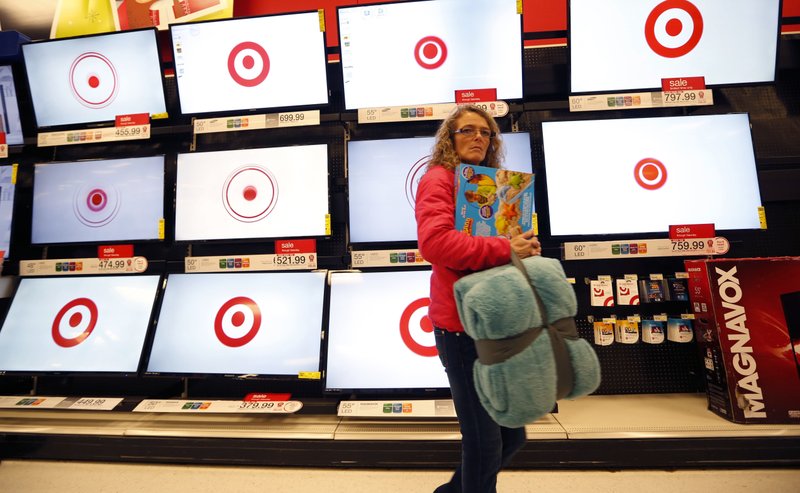 FILE - In this Nov. 28, 2014, file photo, a customer walks past a bank of flat screen televisions at a Target store in South Portland, Maine. Target reports financial results Wednesday, May 18, 2016. (AP Photo/Robert F. Bukaty, File)
