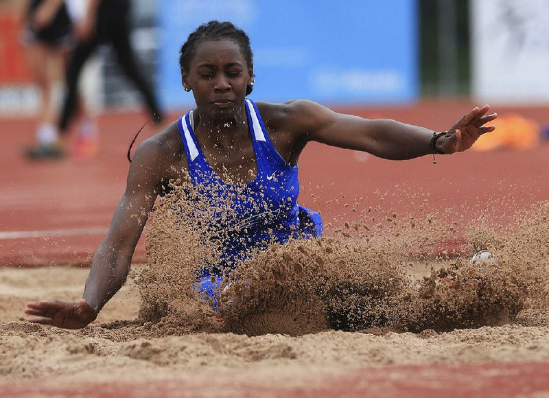 Little Rock Parkview’s Jada Baylark, who scored the best among competitors in the 100 hurdles and the 200 meters, lands in the long jump pit Wednesday in the state high school heptathlon. 