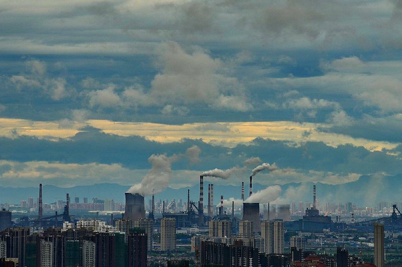 Plumes of smoke and steam rise from a steel plant in Wuhan in central China’s Hubei province in August. 
