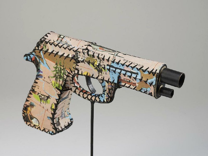 “The Gun Show,” on display starting Saturday at DRAWL Southern Contemporary Art on Kavanaugh Boulevard in the Heights, includes Skin of America (a vintage map handstitched to copper rod on a wooden stand) by Anne Lemanski.

