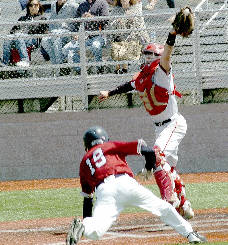 Photo by Rick Peck McDonald County catcher Emitt Dalton stretches for a high throw to force out Joplin&#x2019;s Spencer Cornett during the Mustangs&#x2019; 2-1 loss Saturday in the opening round of the Missouri Class 5 District 12 Baseball Tournament at Joplin High School.