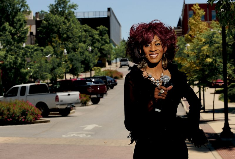 Lady Jazmynne, a transgender performer, poses for a photograph on Block Avenue in Fayetteville. She will perform live at the Block Street Block Party on Sunday.