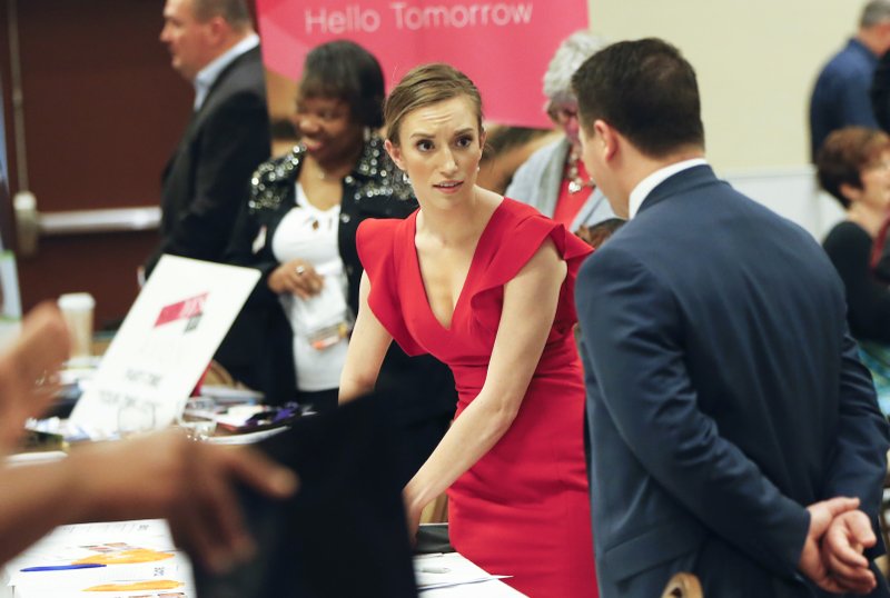 In this Wednesday, March 30, 2016, file photo, job recruiters work their booths at a job fair in Pittsburgh. 