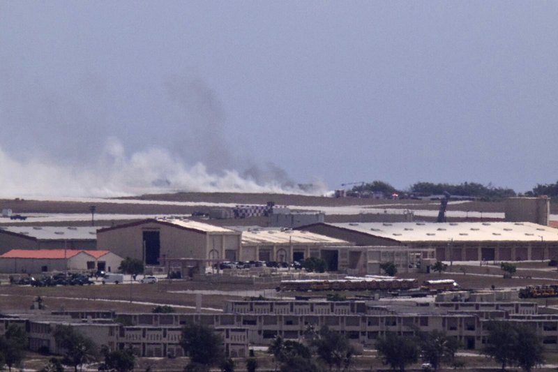 Smoke from the crash of a B-52 is seen on the flight line at Andersen Air Force Base from Mt. Santa Rosa, Yigo Guam, Thursday, May 19, 2016. The U.S. Air Force said Thursday a B-52 crashed on Guam shortly after takeoff, but all seven crew members made it out safely. No injuries were reported. (Rick Cruz/The Pacific Daily via AP) MANDATORY CREDIT