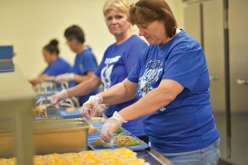 Debra Million, from right, Phyllis Rogers, Elria Garibay and Hipotlia Dominguez plate lunches for students at Davis Elementary School in Alexander.   The Shannon Hills Boys & Girls Club, located at the school, and the Boys & Girls Club of Byrant will offer free breakfast and lunch to youths, ages 18 and younger,  Monday through Friday, beginning June 6, as part of a Summer Food Program.