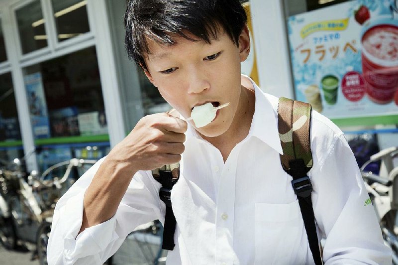 Keima Nagata, 16, eats a Garigari-kun, a popular ice-cream bar, at a store in Kawasaki, Japan. 