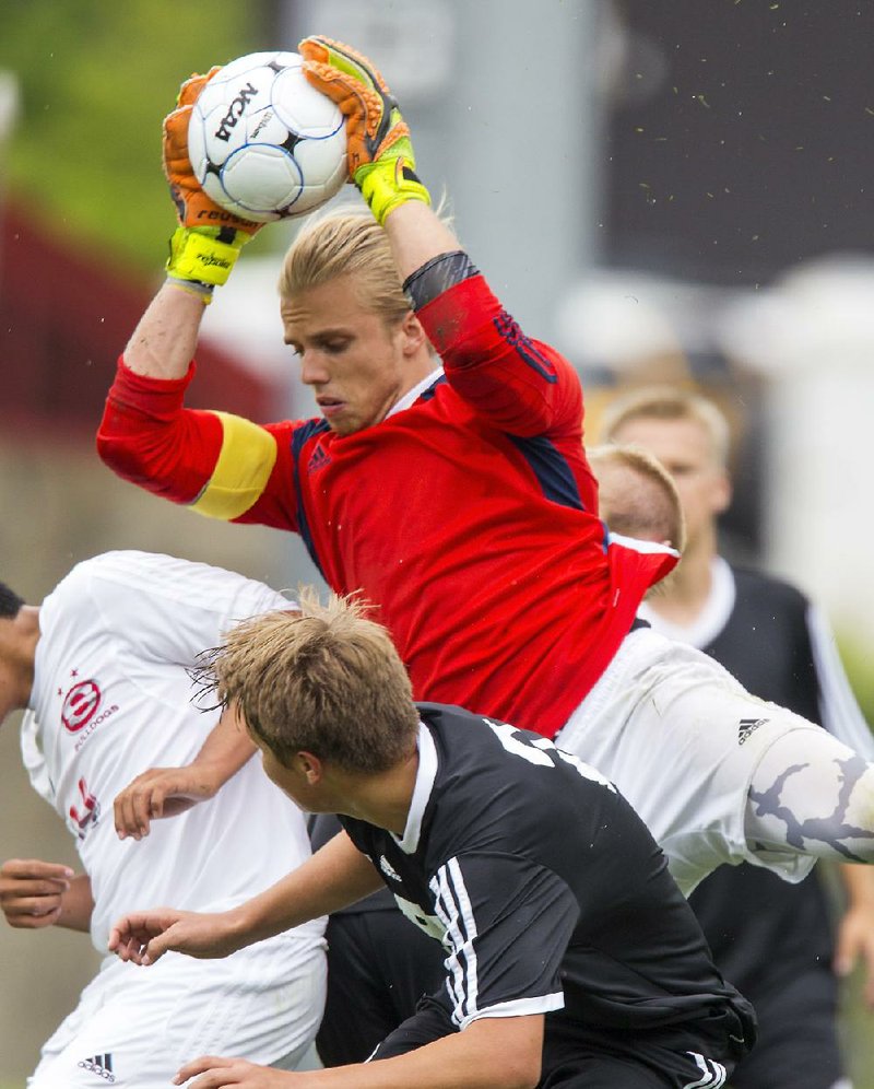 Bentonville senior goalkeeper Ben Barron makes a save during the Tigers’ 2-0 victory over Springdale on Friday during the Class 7A boys soccer state championship game at Razorback Field in Fayetteville. It was Bentonville’s third consecutive title.