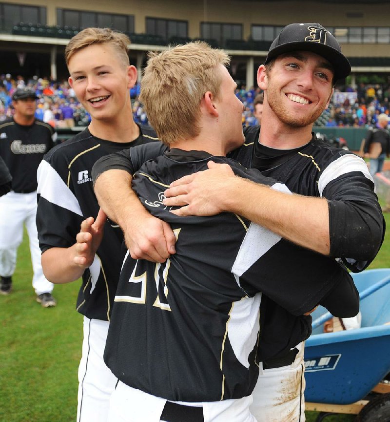 Jonesboro pitcher Skyler Boyle (right) gets a hug from Tate Snider after holding league rival Mountain Home to just three hits in the Hurricane’s 8-1 victory in the Class 6A state championship game.