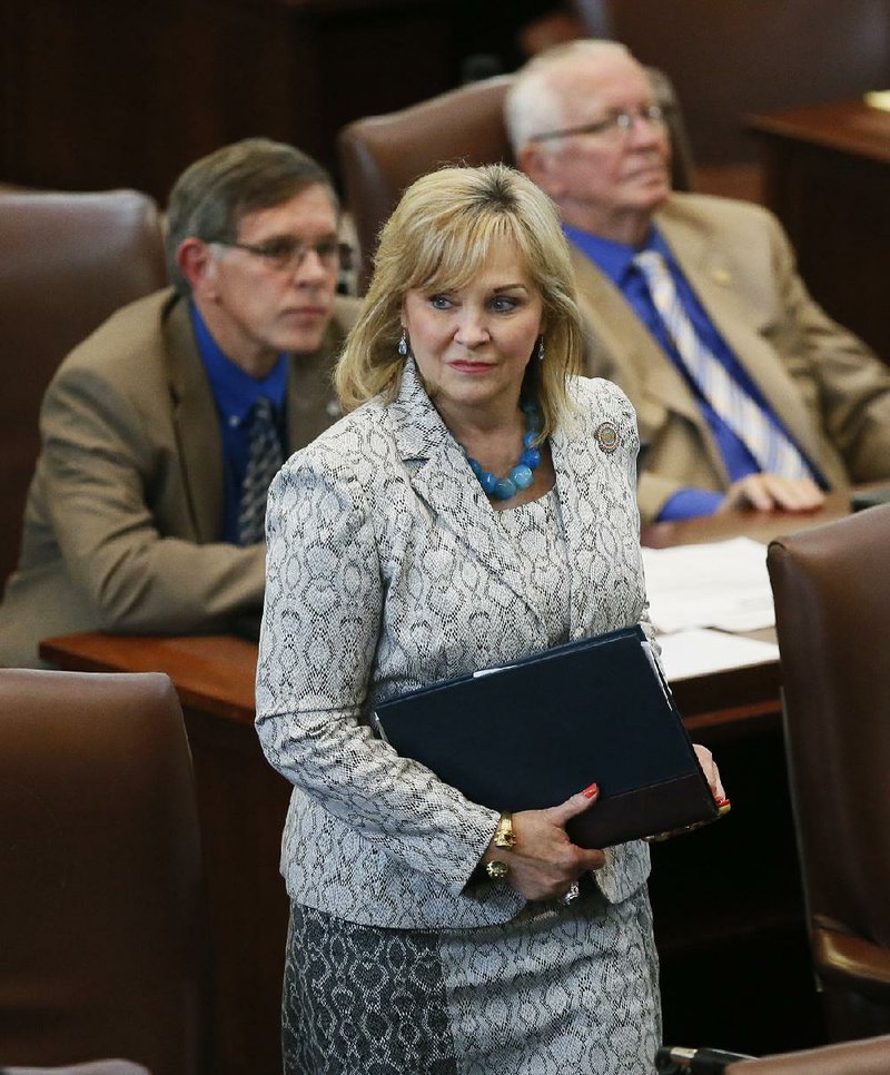 In this May 18, 2016, file  photo, Oklahoma Gov. Mary Fallin walks on the floor of the Oklahoma House in Oklahoma City. 