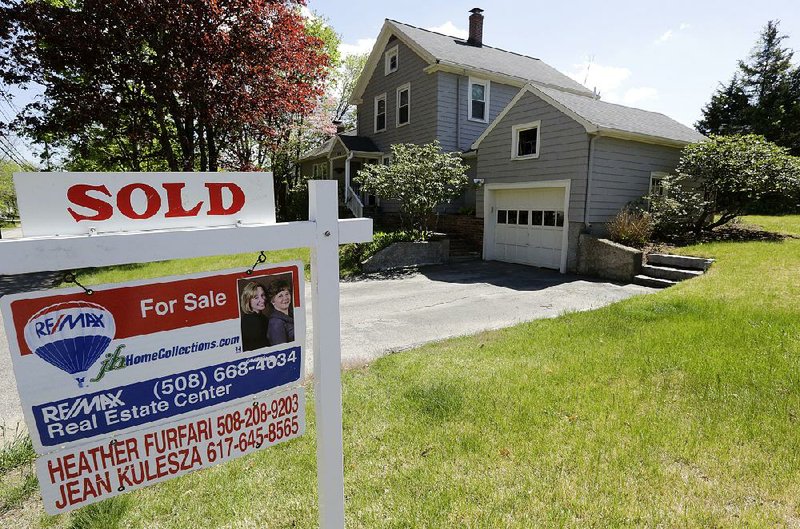 A “Sold” sign in front of a house in Walpole, Mass., is seen earlier this week.