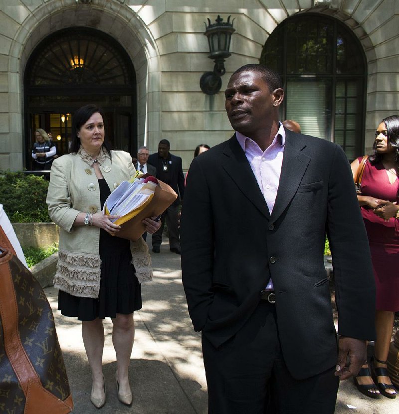 Former boxing champion Jermain Taylor leaves the Pulaski County Courthouse on Friday after receiving a six-year suspended sentence in nine felony cases he pleaded guilty to in December. 