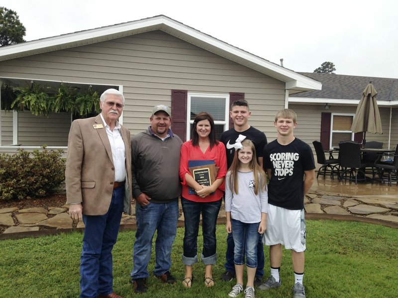  Benton County Judge Bob Clinard (left) is shown with the Moorman family of Gravette. The Moorman family was named as the Benton County Farm Family of the Year.