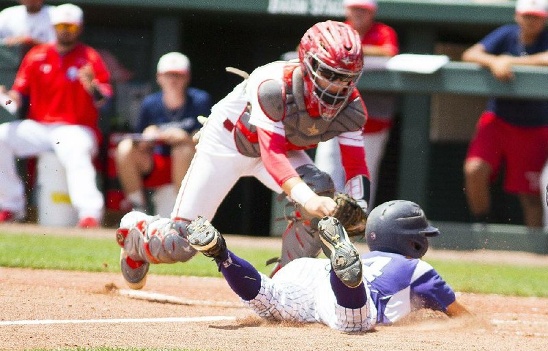 Booneville’s Trent Wooldridge (right) is tagged out at home by Horatio’s Cole Boyd to end a Bearcats’ threat during Saturday’s Class 3A state title game. The Lions put an end to Booneville’s 10-game winning streak with a 7-0 victory.