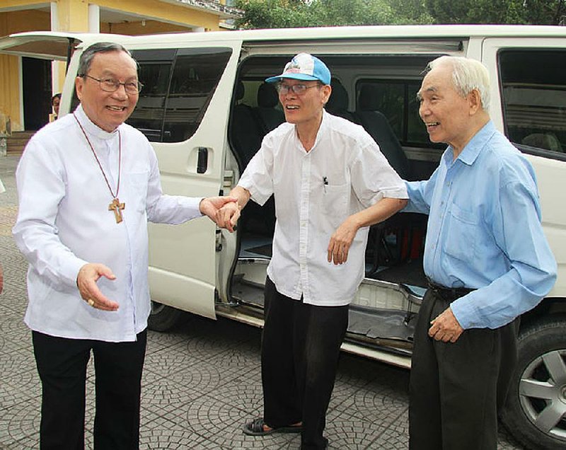 Nguyen Van Ly (center), a Catholic priest, is welcomed Friday by Archbishop Tadeo (left) and a colleague in the Catholic Archdiocese of Hue, Vietnam, after Ly was freed early from the eightyear prison term he received for spreading propaganda against the state.