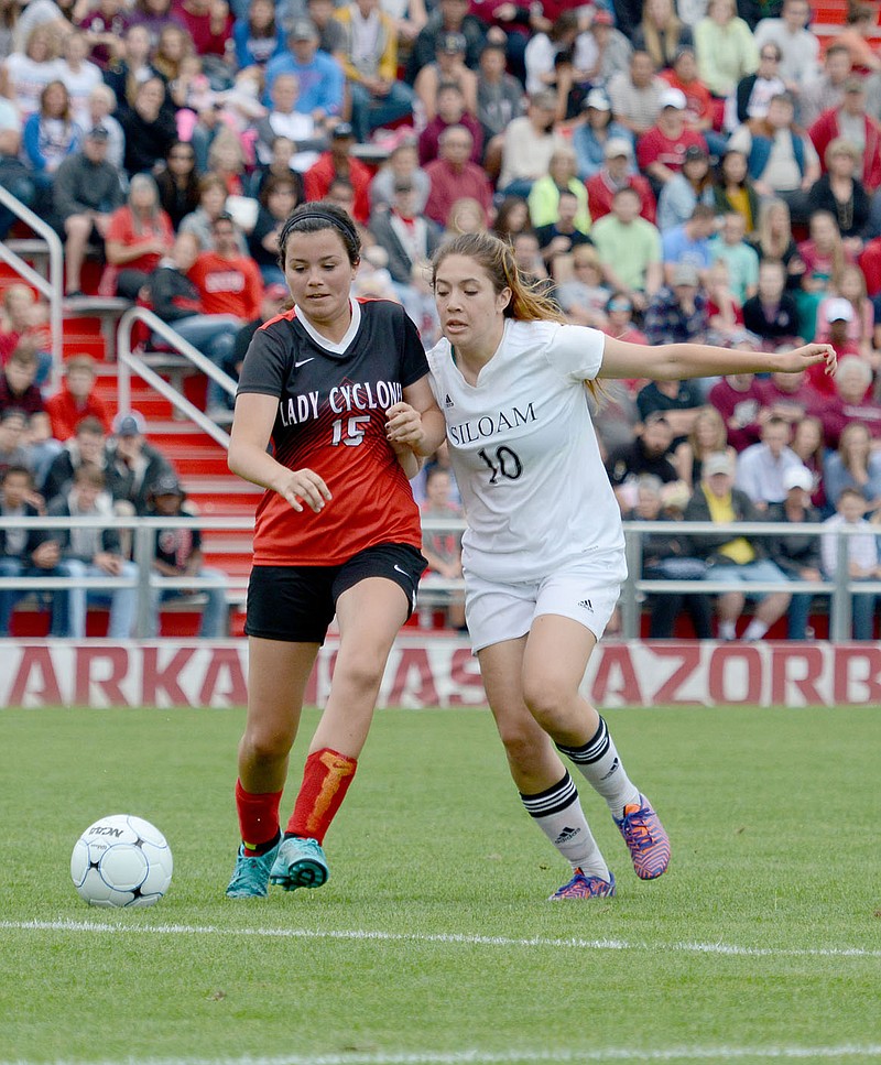Bud Sullins/Special to Siloam Sunday Sophomore Averie Headrick battles a Russellville player for the ball Friday in the 6A state championship game at Razorback Field.