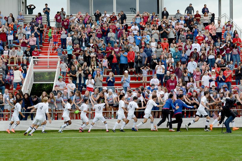 Bud Sullins/Special to Siloam Sunday Siloam Springs boys soccer players celebrate with their fans, including the Siloam Springs girls team, after winning the state title on Friday at Razorback Field in Fayetteville.