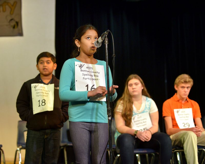 Pavani Chittemsetty spells a word during the 2015 Benton County Spelling Bee in White Auditorium at Northwest Arkansas Community College in Bentonville.